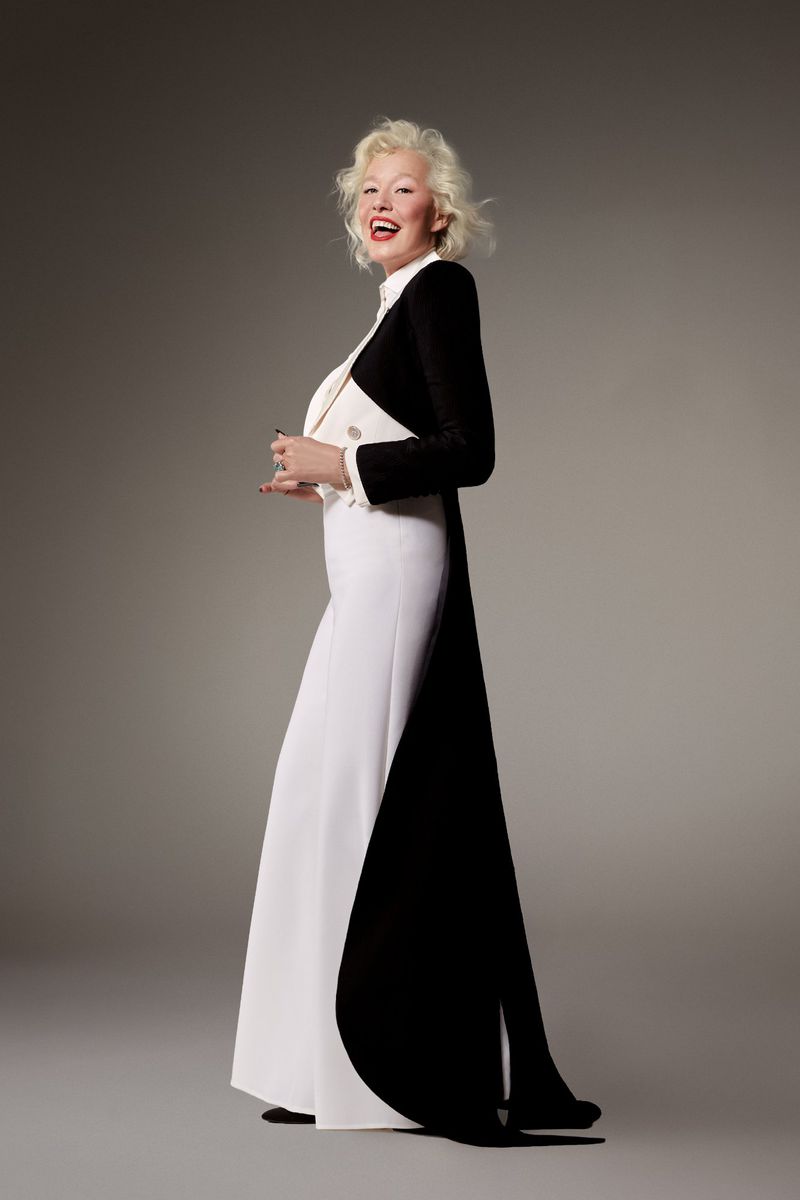 Ellen von Unwerth in a black and white tuxedo gown by Alexis Mabille against a neutral studio backdrop