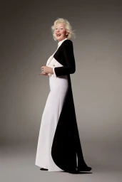 Ellen von Unwerth in a black and white tuxedo gown by Alexis Mabille against a neutral studio backdrop