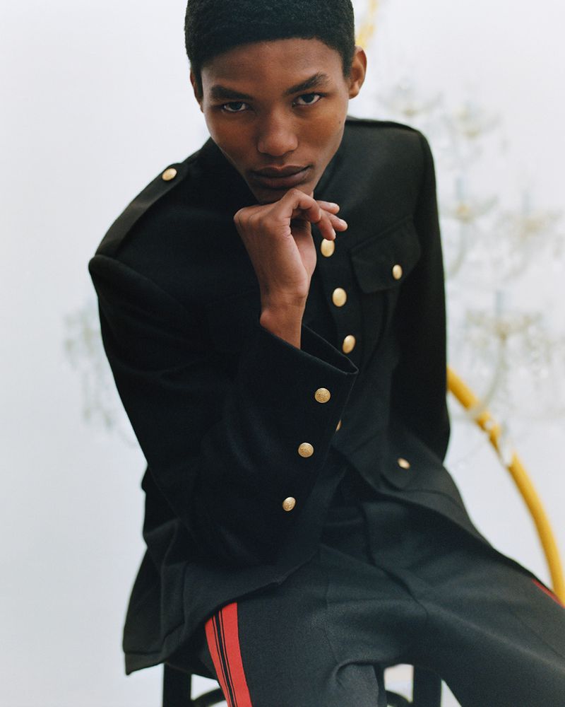Model Lebo Malope wearing a black uniform jacket with gold buttons for Wales Bonner F/W 25