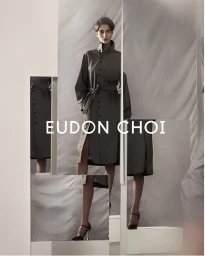 Model in a belted grey coat standing within a multi-panel studio composition for Eudon Choi prefall 2025