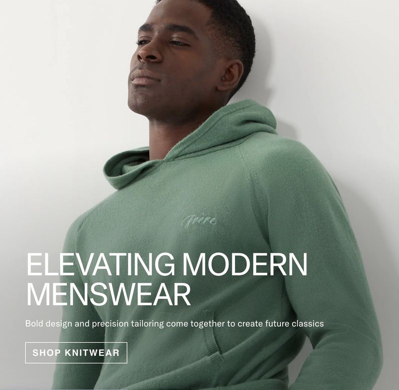 Studio shot of a Black male model wearing a hooded knit sweatshirt, showcasing modern menswear fashion against a neutral background.