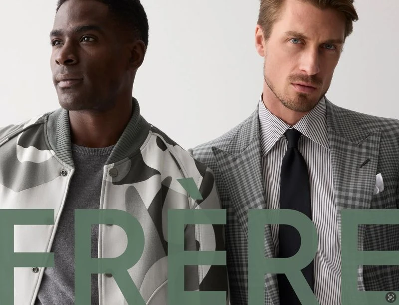 Two adult men pose in fashionable jackets, one camo, one grey plaid, against a plain background. Text overlay reads FRERE.