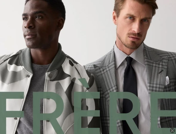 Two adult men pose in fashionable jackets, one camo, one grey plaid, against a plain background. Text overlay reads FRERE.