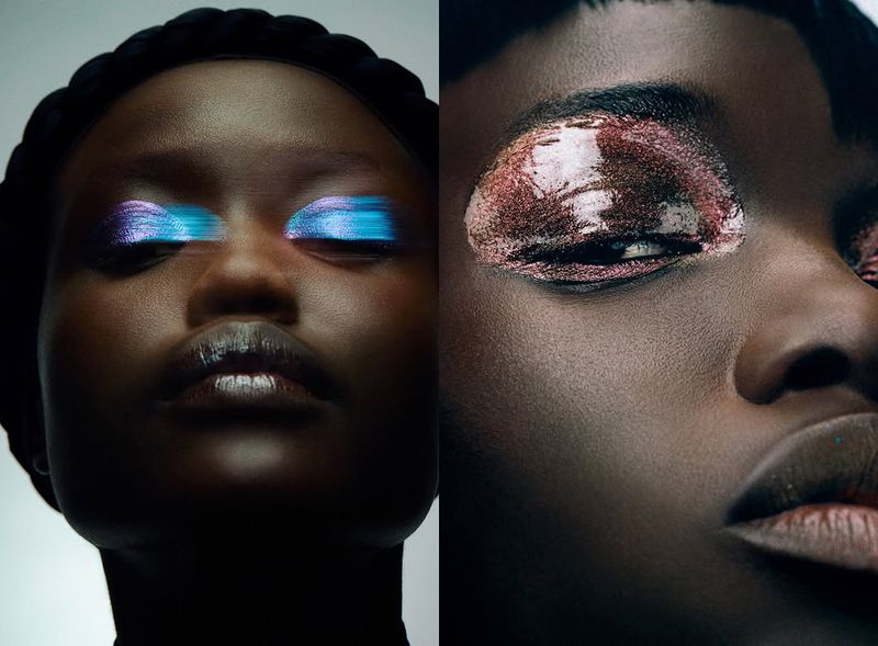 Beauty shot featuring two dark-skinned Black female faces in close-up, showcasing dramatic eye makeup in blue and copper tones against a dark background.