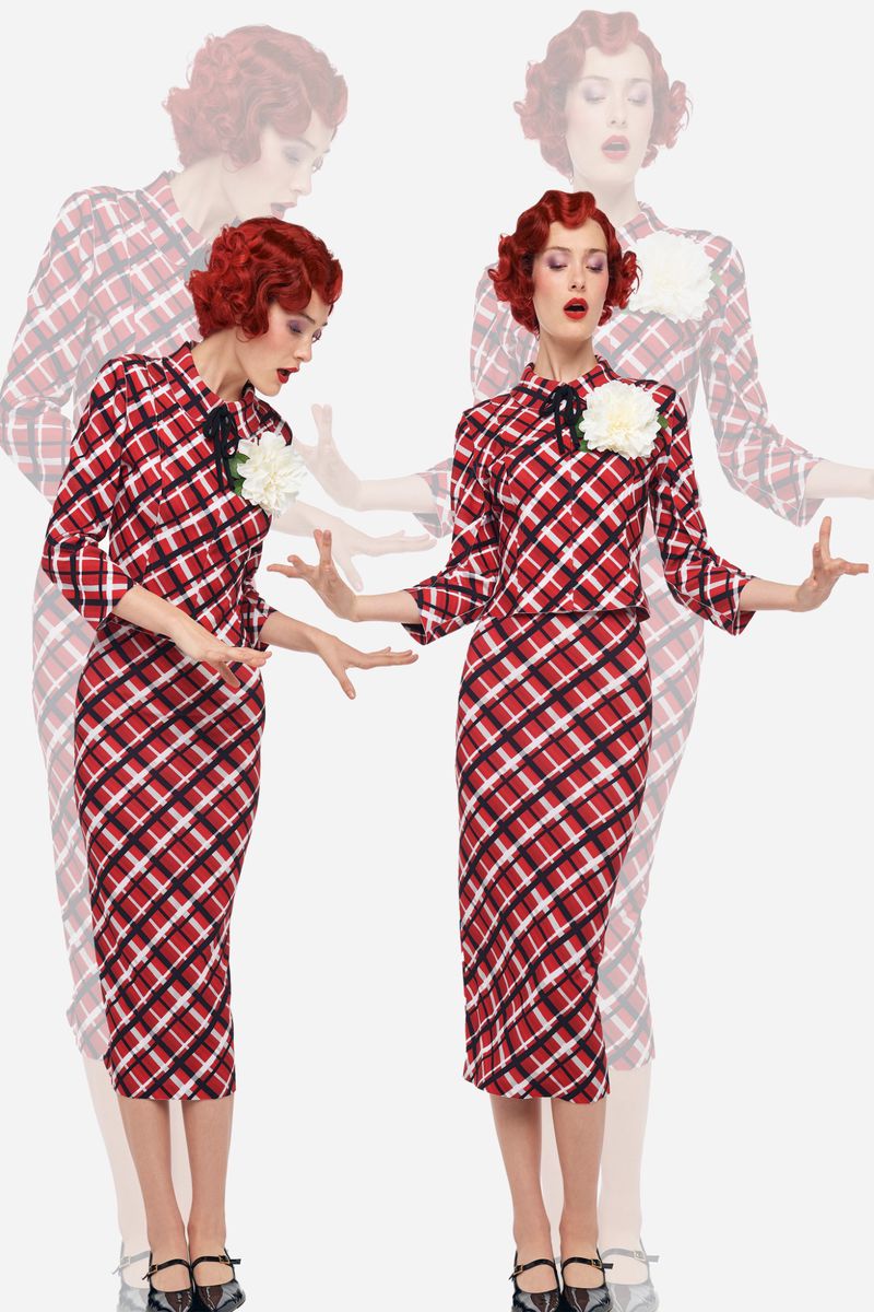 Woman in a plaid dress strikes a pose against a white background with light transparent duplicates creating a motion effect.