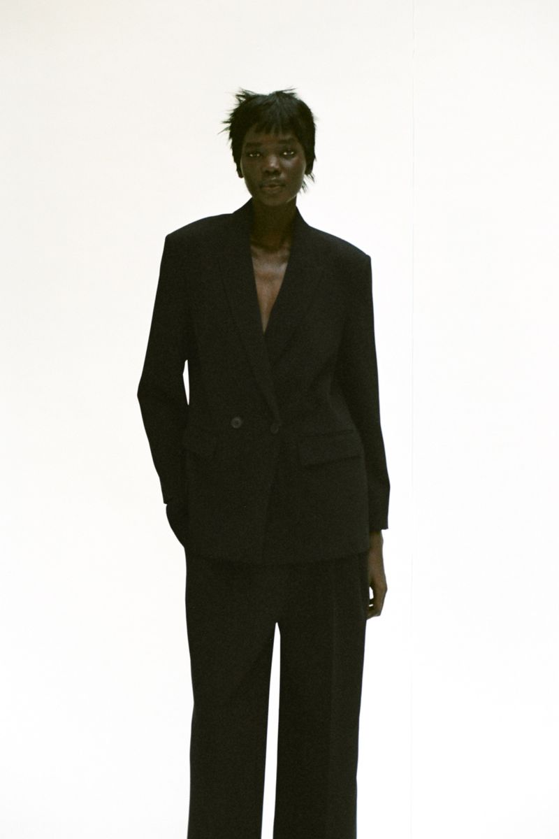 Model wearing a black blazer and matching trousers against a white background for Zara A/W 25