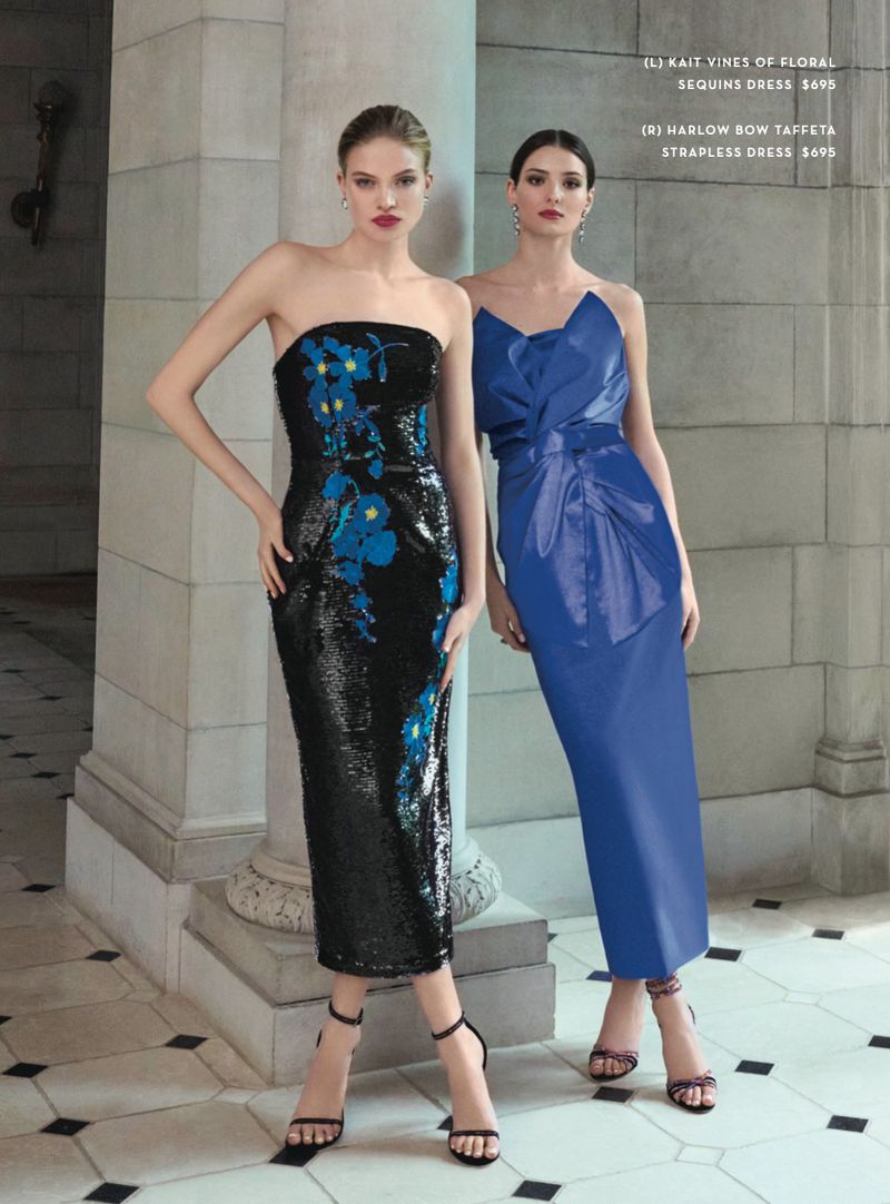 Two women stand wearing strapless evening dresses in black sequins with floral accents and blue taffeta with draped front detail.