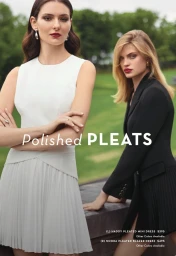 Two female models posing outdoors for Milly Fall 2024, wearing a white pleated dress and a black blazer dress.