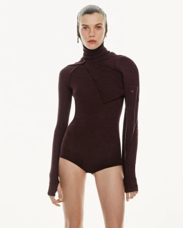 Model wearing a dark burgundy turtleneck bodysuit against a plain white background for Victoria Beckham Pre-Fall 2025 lookbook