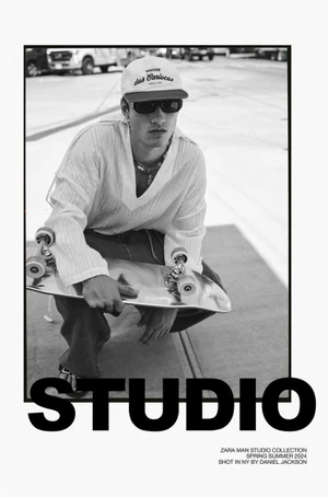 Monochrome fashion portrait of male model Serge Rigvava holding a skateboard and wearing sunglasses and a cap, shot by Daniel Jackson for Zara.
