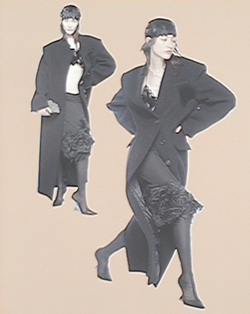 Two models wearing dark oversized blazers and hats against a pale background for The Attico S/S 25 campaign.