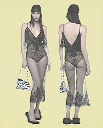 Fashion shot of a woman in a black lace bodysuit with a sheer dress, holding a zebra-striped purse, in front of a pale yellow background.
