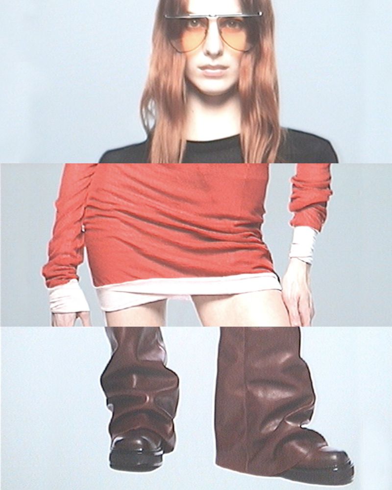 Fashion shot featuring a woman with red hair wearing sunglasses, a red dress, and high brown boots against a light grey background.