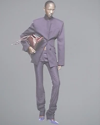Model wearing a tailored dark suit holding a handbag against a plain grey background