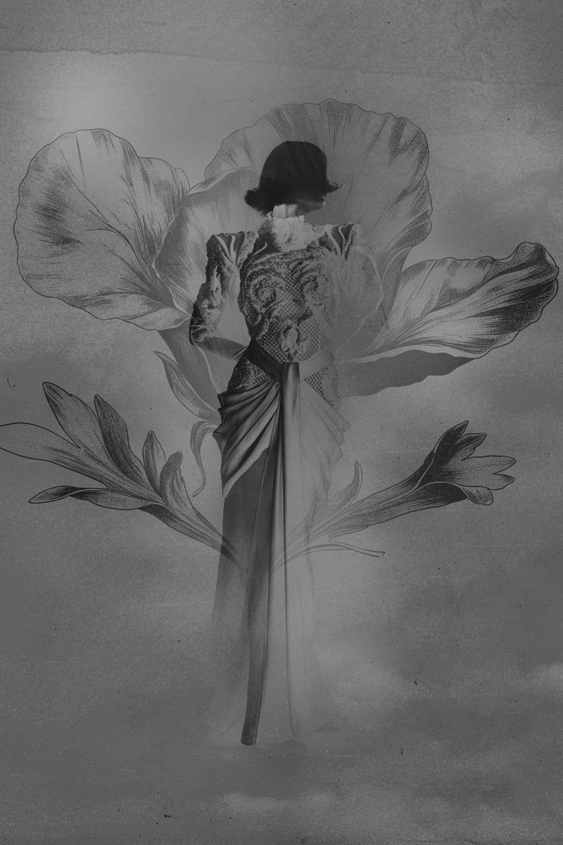 Monochrome image of a woman in an ornate dress posing with a surreal floral backdrop, rendered in grayscale with soft, diffused lighting.