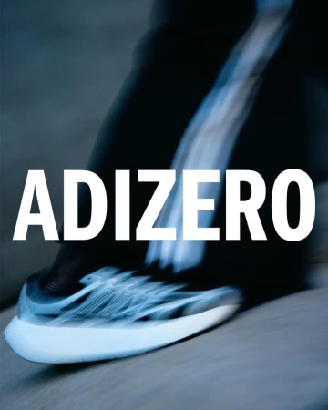 Close-up shot of a black and white Adidas ADIZERO running shoe in motion, with a blurred grey background and large ADIZERO text overlay.