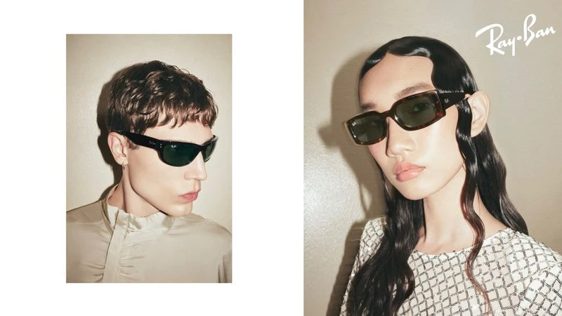 Two models showcase Ray-Ban sunglasses in a split portrait composition with a neutral color palette and brand logo visibility.