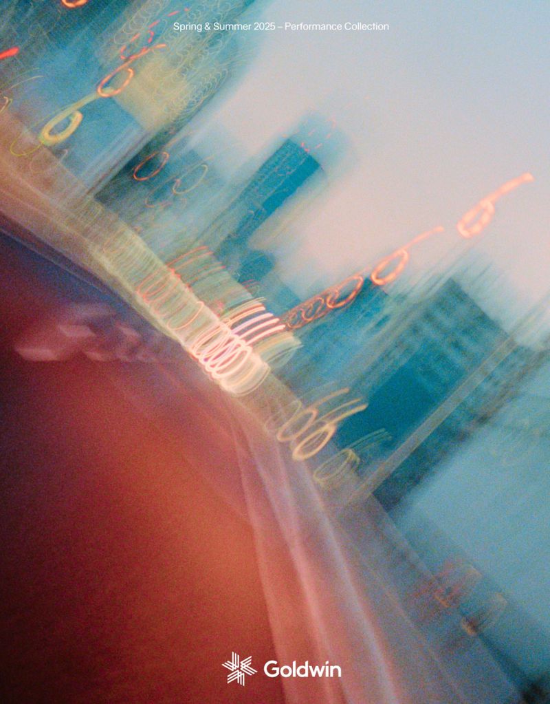 Abstract blurred architectural image with a mix of orange, blue, and white lights, evoking a dynamic urban environment.