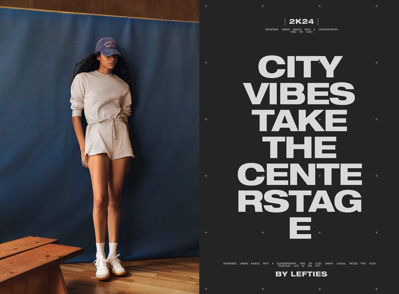 Woman in sweatshirt and shorts poses in front of a blue backdrop next to a poster with the text 'CITY VIBES TAKE THE CENTER STAGE'.