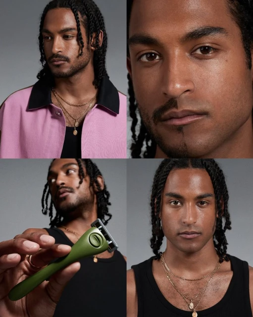 Close-up of a man with braided hair, wearing a black tank top and gold necklaces; holding a green razor, set against a grey backdrop.
