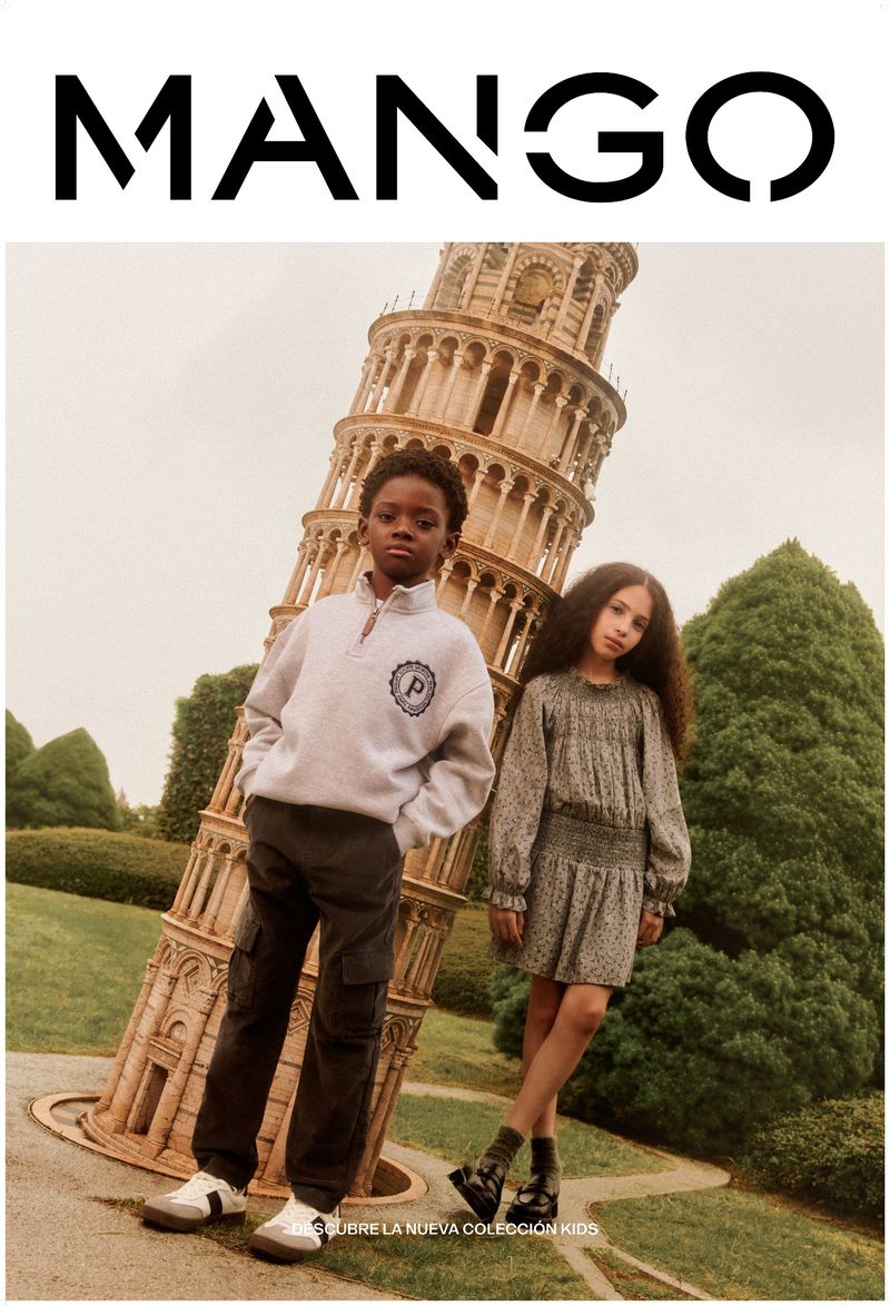 Two kids model Mango clothing near the Leaning Tower of Pisa. The boy wears a grey sweatshirt and cargo pants, while the girl wears a floral dress.