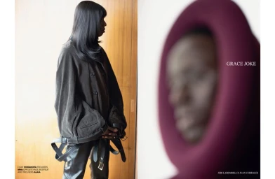 Fashion editorial spread of Le Diouck in an oversized belted jacket and dark trousers beside a blurred sculptural portrait.
