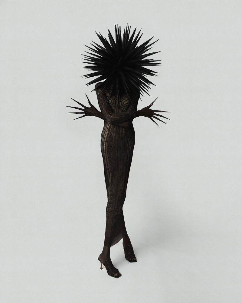 Surreal fashion portrait featuring an individual in a spiked headpiece and textured dress, posed against a light grey studio backdrop.