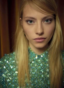 Model Annie Arnander wearing a shimmering teal sequin collared top in a close-up portrait for Harper's Bazaar Germany.