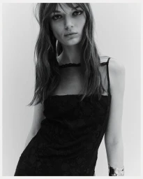 Model in black lace dress against a light background for H&M Tailoring Holiday