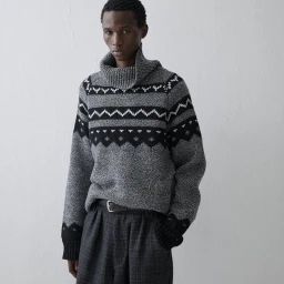 Model Gaye Serigne in a grey patterned turtleneck sweater and dark trousers for U Repubblica photographed by Luca Strano