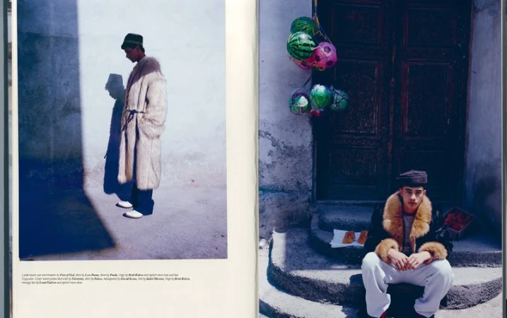 Two-page fashion spread features two men in vintage-inspired attire against urban backdrops; one stands in bright sunlight, the other sits.