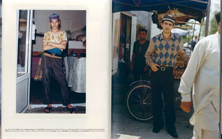 Two men model traditional Central Asian clothing in an indoor-outdoor setting, featuring vibrant textiles, natural light, and cultural elements.
