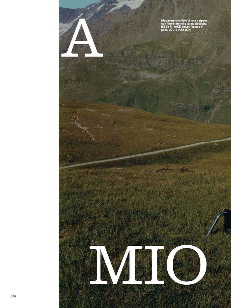 Landscape shot of alpine mountain range, rolling hills, and green grass in an outdoor editorial fashion setting with text overlays.
