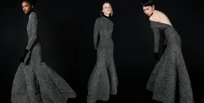Three fashion models showcase long gowns with dotted patterns in a studio setting, emphasizing the dresses' flowing silhouettes and unique design.