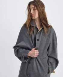 Model wearing a grey wool coat against a plain white studio background for ICICLE AW 2025.