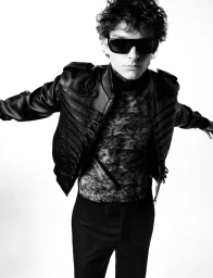 Mason Thames wearing black sunglasses, a patterned lace top, and an embellished jacket against a plain white background for V Man.