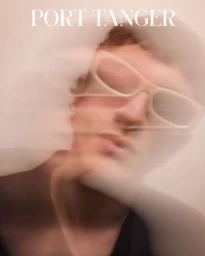 Close-up motion-blurred portrait of a person wearing light-colored sunglasses for Port Tanger