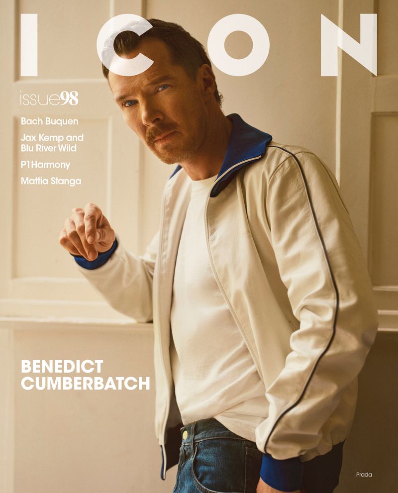Magazine cover featuring Benedict Cumberbatch in a white jacket, posing indoors against a light beige wall with visible text and branding.