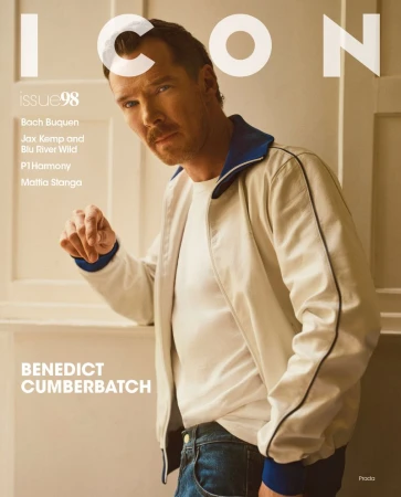 Magazine cover featuring Benedict Cumberbatch in a white jacket, posing indoors against a light beige wall with visible text and branding.