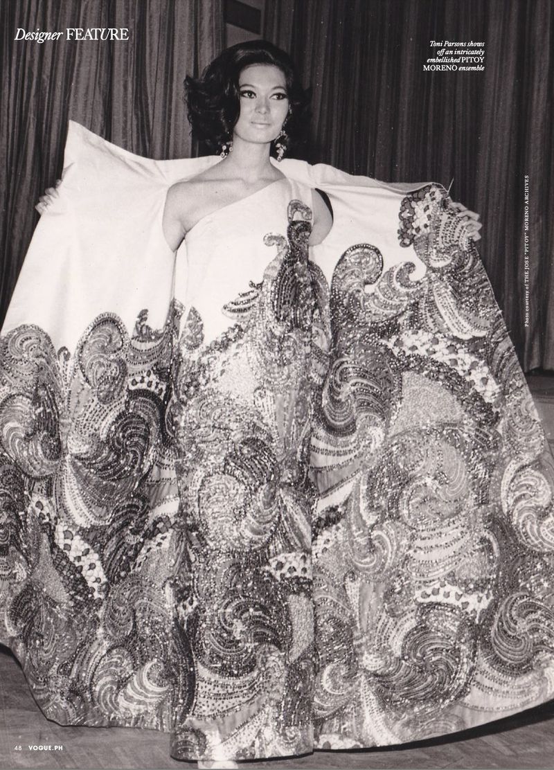Model wearing an ornate embroidered evening gown with a wide patterned cape in a fashion editorial for Vogue Philippines.