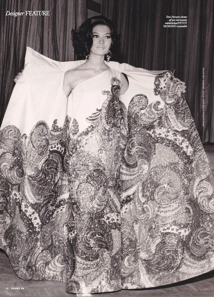 Model wearing an ornate embroidered evening gown with a wide patterned cape in a fashion editorial for Vogue Philippines.