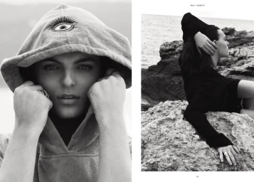 Black and white editorial diptych of Damian Hurley wearing an eye-embroidered hood and reclining on rocky coastal terrain.