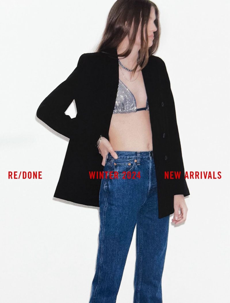 A woman poses in jeans, a sparkling top, and a blazer against a white background with text overlay, showcasing a casual, modern style.