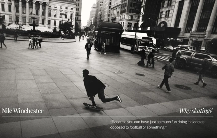 Monochrome shot of a male skateboarder riding on a city plaza with pedestrians and urban elements in the background. Editorial style.