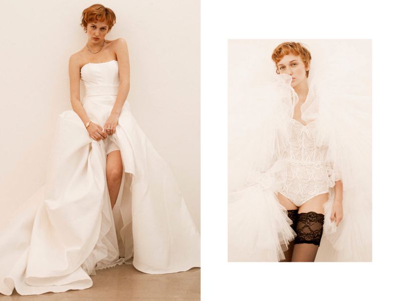 Woman in wedding dress and woman in lace bodysuit with black stockings posing in front of a white wall.
