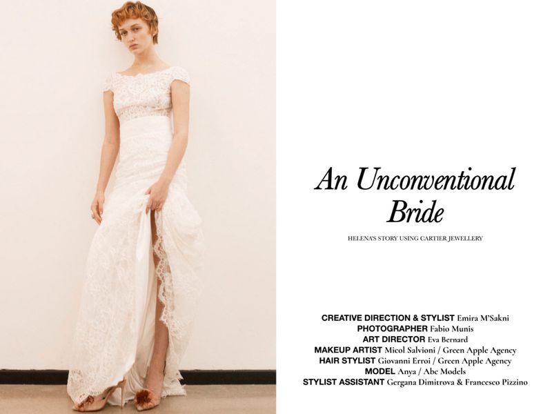 Woman in lace wedding dress poses against neutral backdrop in fashion editorial photography, shot with soft light, clean setting.
