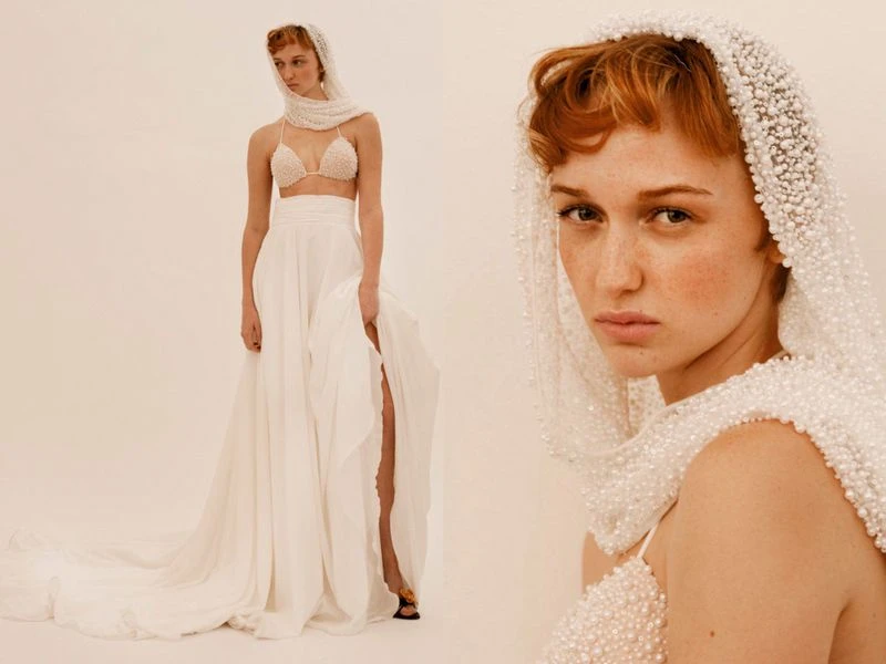 A red-haired woman in a white skirt and beaded top and head covering poses in a studio setting, with a crop showing her facial details.