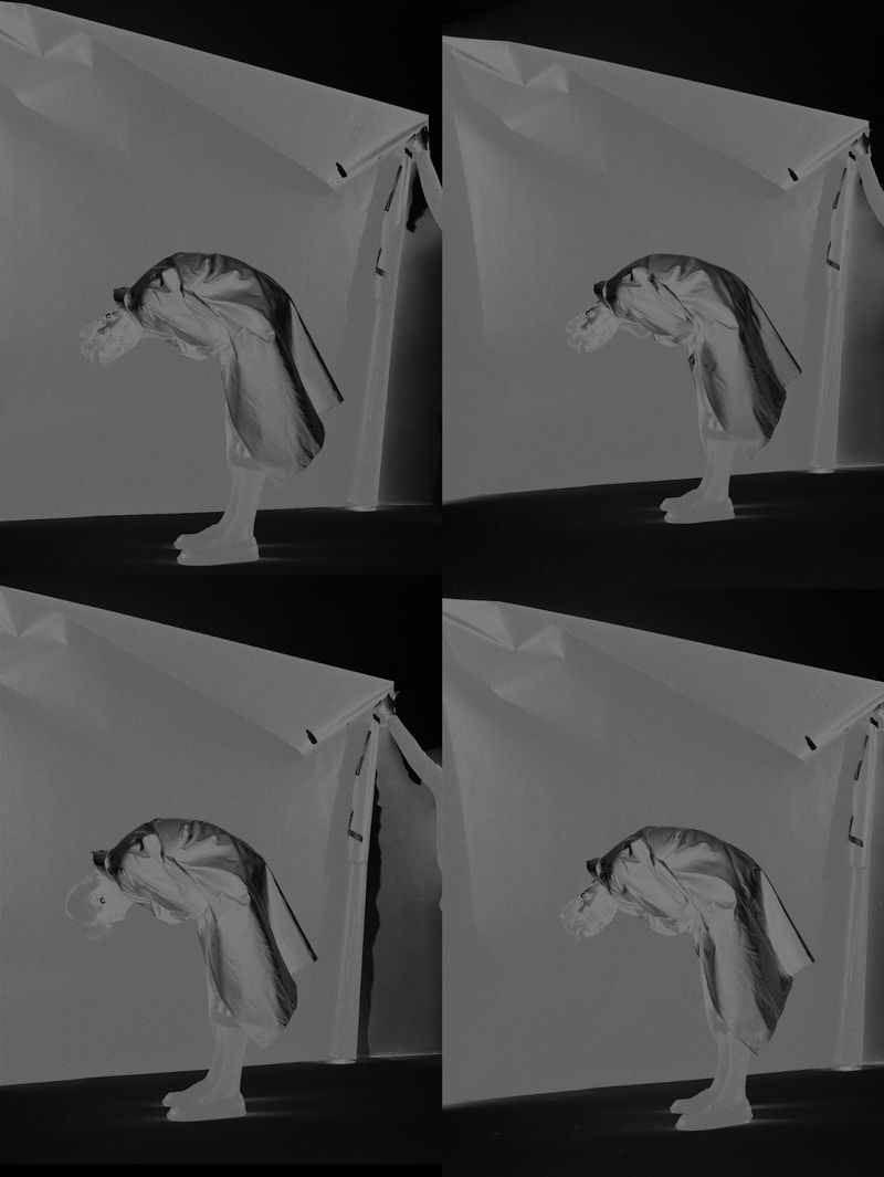 Monochromatic image of a person bending over inside a tent-like structure, repeated four times in a collage format.