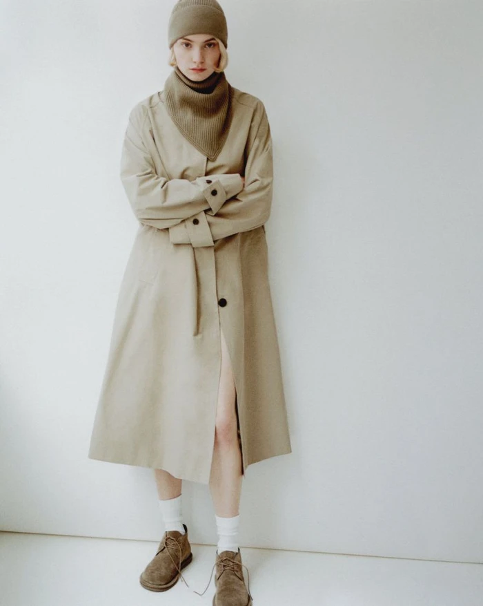 Model wearing a beige coat, matching beanie, and scarf against a white background for the Appointment book project.