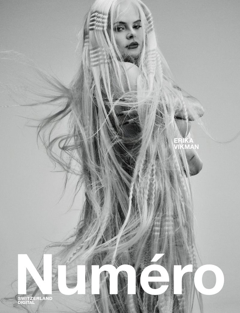 Magazine cover featuring a woman with long blonde hair styled in intricate patterns against a grey background with 'Numero' text.